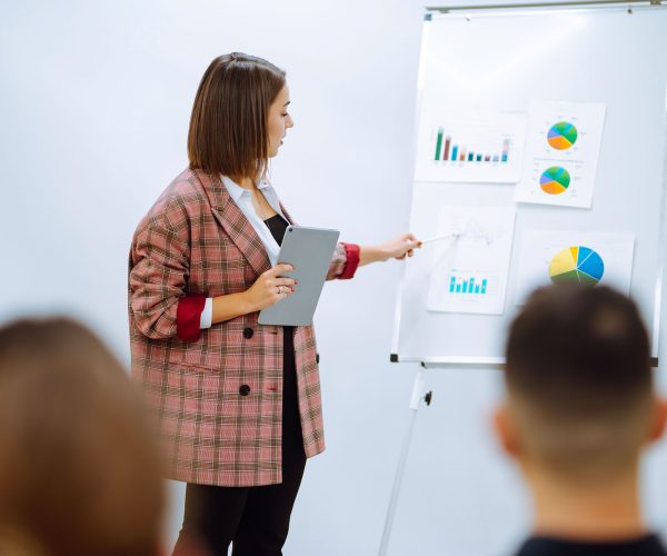 young-woman-coach-speaker-giving-flipchart-present-2022-12-14-05-07-19-utc